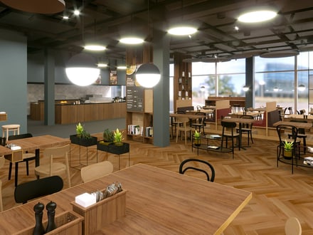 Moderne Restaurant-Innenansicht mit Holzböden und Tischen.