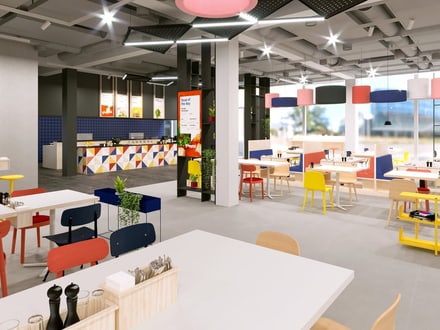 Moderne Cafeteria mit bunten Möbeln und geometrischen Mustern.