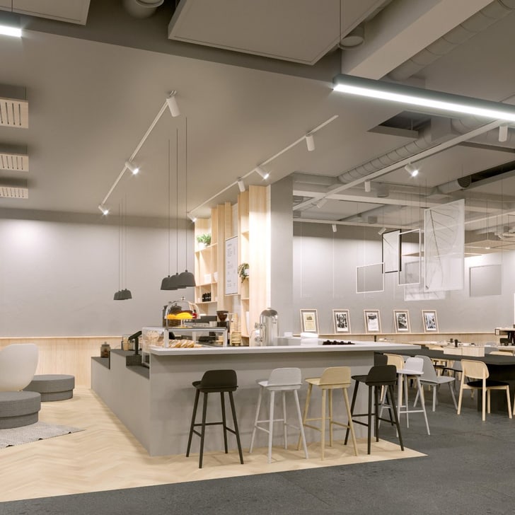 Modernes Café-Interieur mit Barbereich und Tischen.