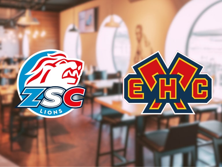 ZSC Lions und EHC-Logos vor einem unscharfen Café-Hintergrund.