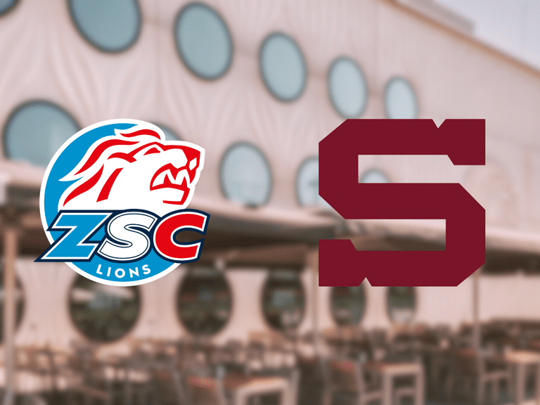 Logos der ZSC Lions und eines roten S vor Gebäude mit runden Fenstern.